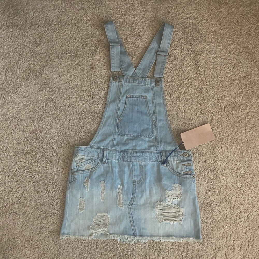 Distressed denim overalls